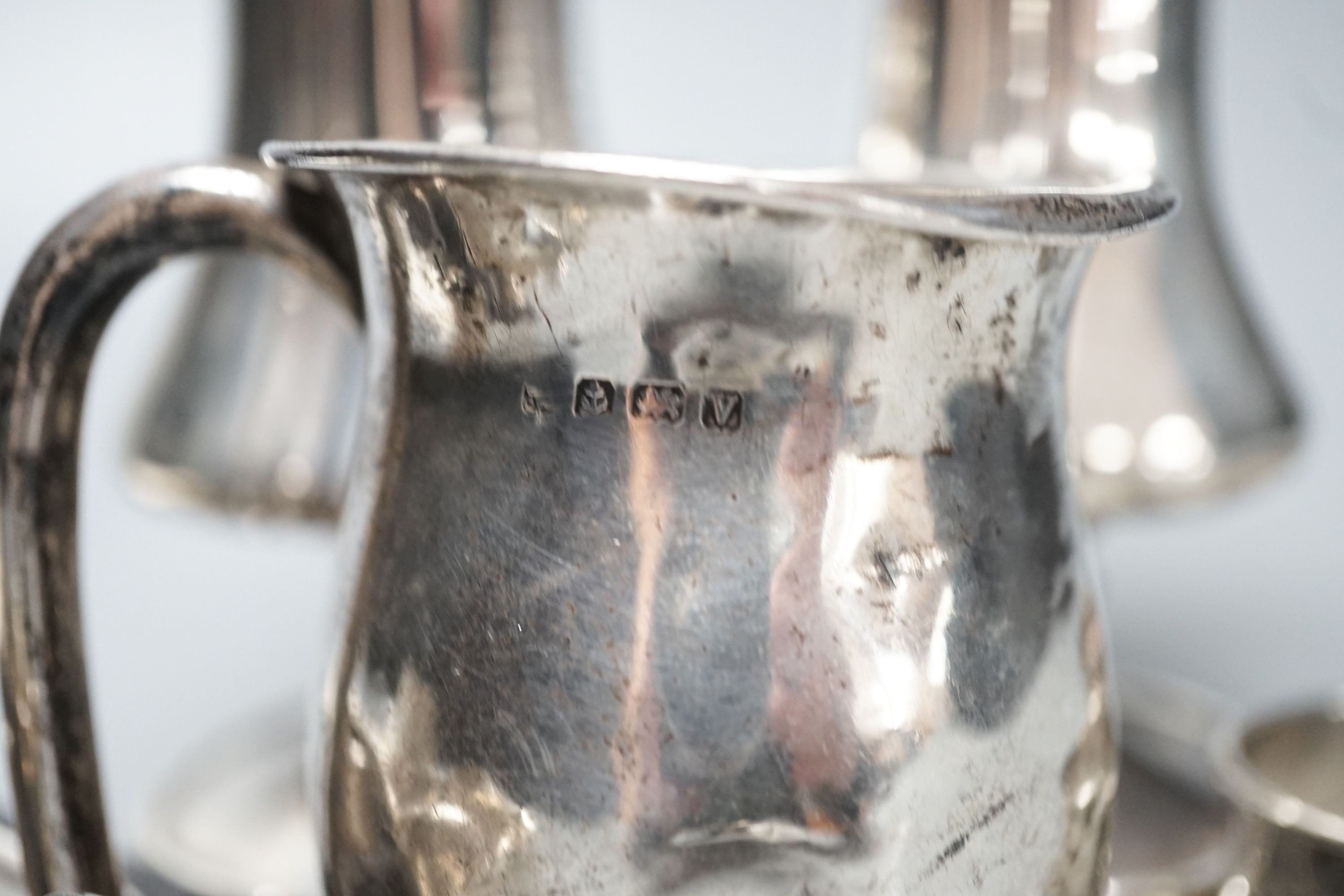 A pair of silver posy vases, a silver mug, a silver dish, five silver napkin rings, two button hooks and a cased silver pusher, weighable silver 9.5oz.